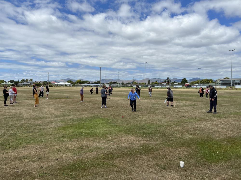 A group of people are standing in a field.