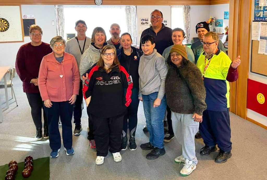 A group of people are posing for a picture in a room.