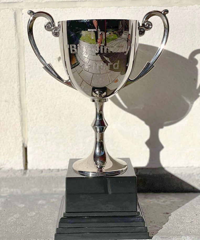 A silver trophy with the word billiards on it