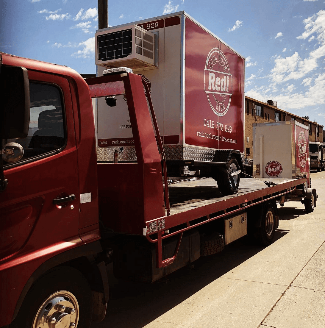 Redi Coolroom Hire placing a Refrigeration unit on a back of a truck in Melbourne
