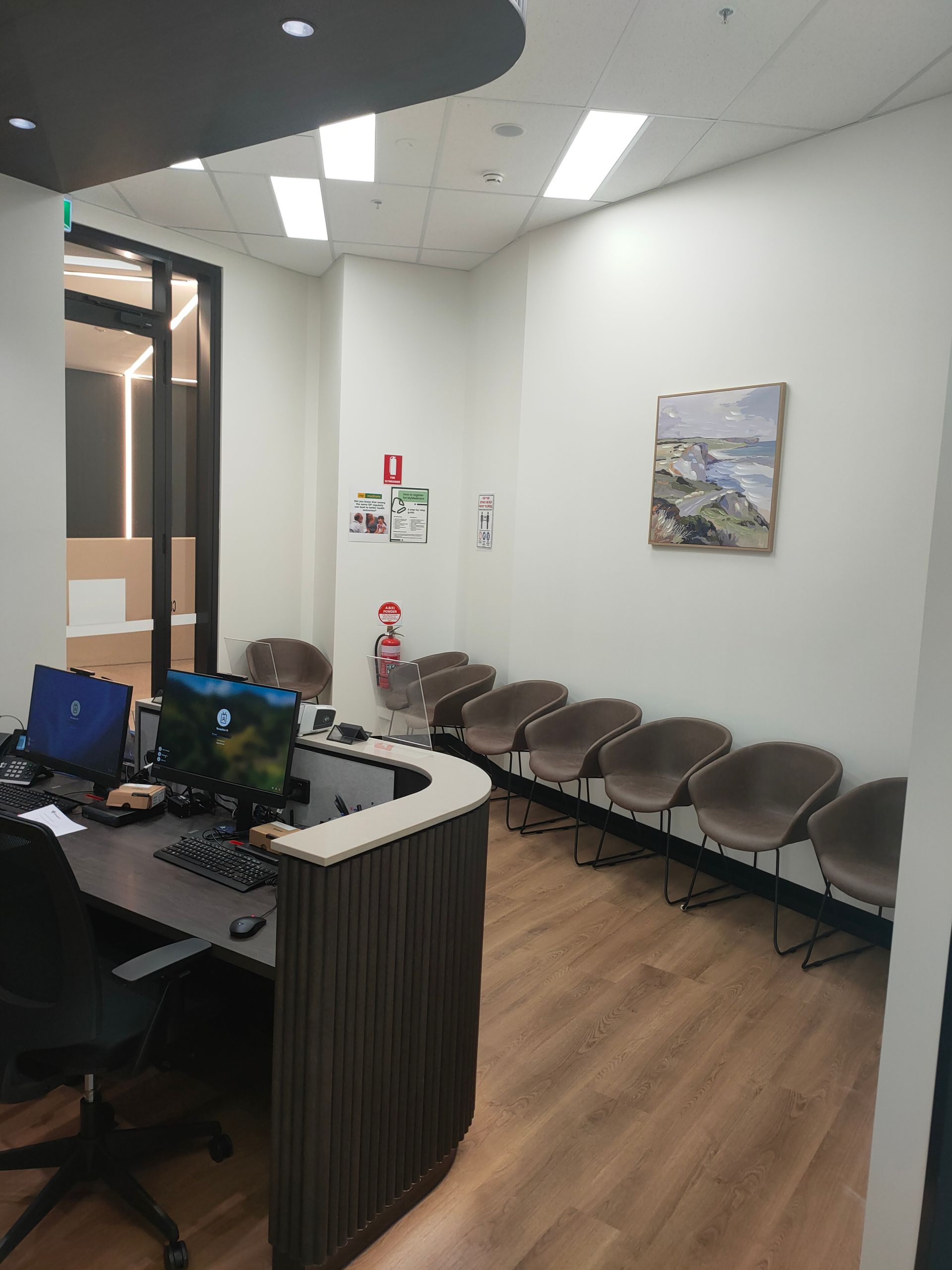 GP Belconnen medical centre entrance doors showing the waiting area, Medicare sign and patient information posters.