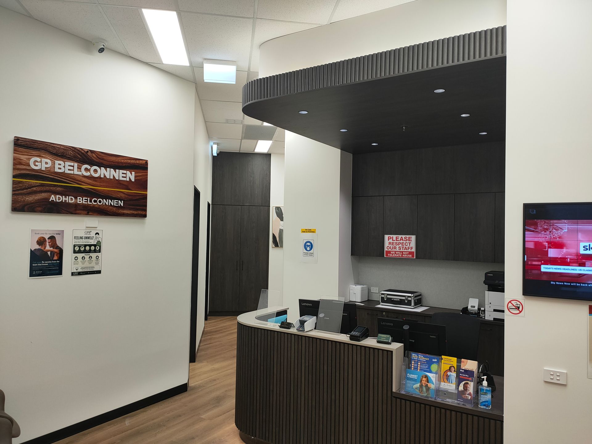 GP Belconnen medical clinic reception area with front desk, signage and patient information brochures.