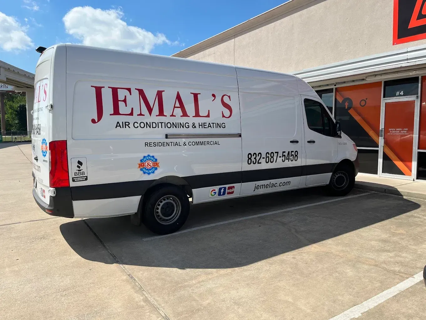 White Jemal's Air Conditioning Services van parked outside a building