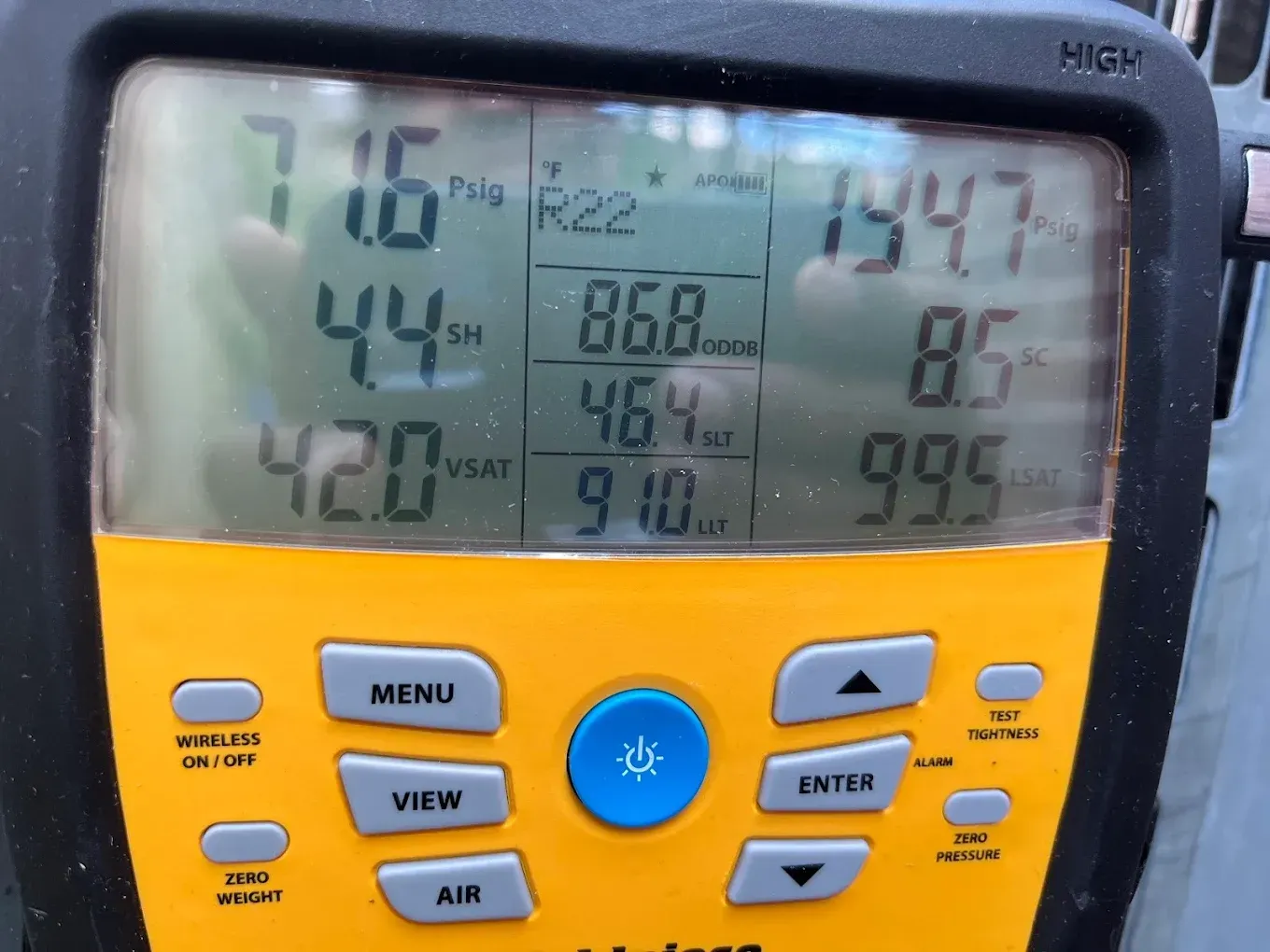 Yellow HVAC control panel display showing temperatures and settings with buttons below