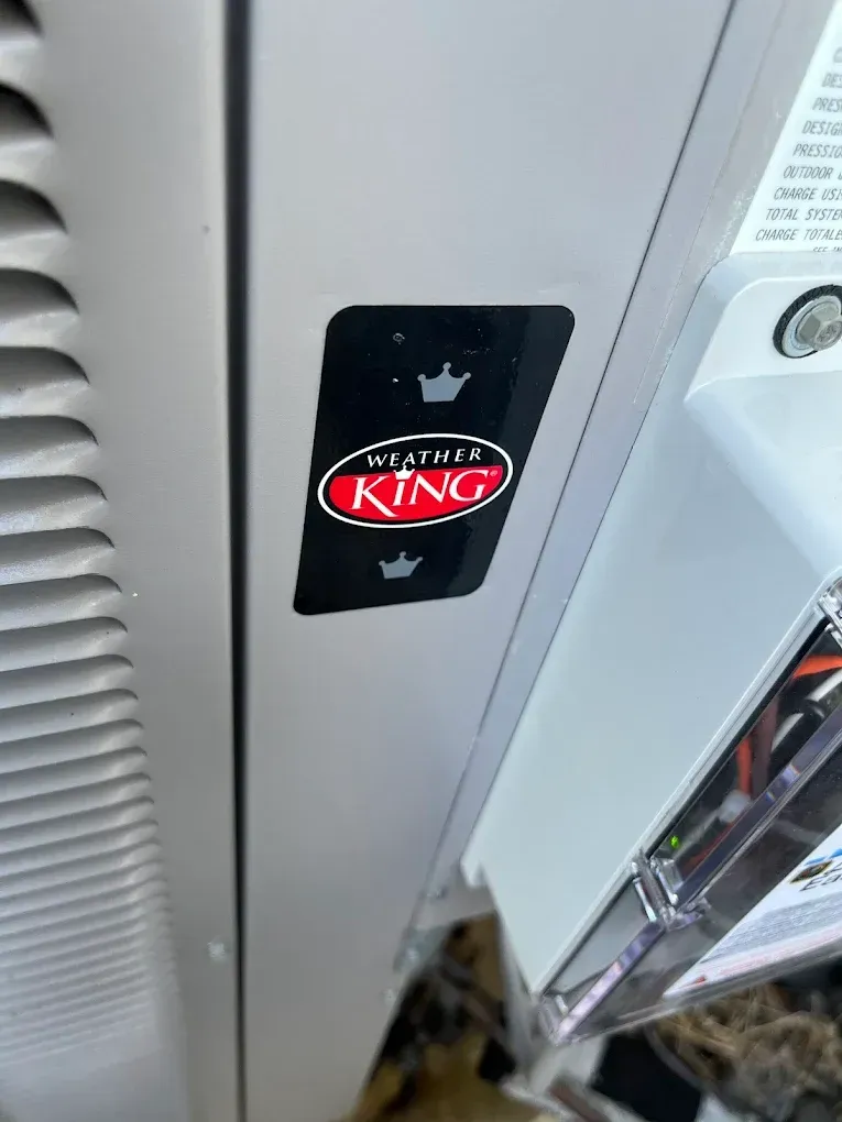 Black King-branded card on a white cabinet beside a vented panel and clear acrylic bin