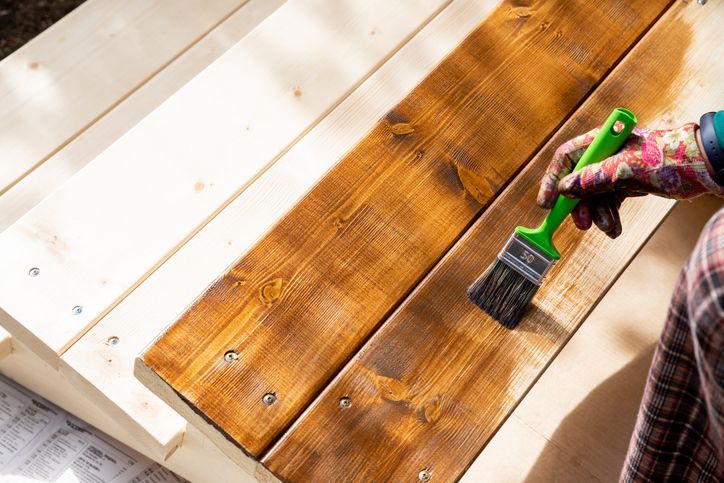 Painting wooden patio deck with protective varnish