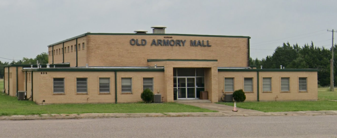 A large brick building with the words old armory mall on it