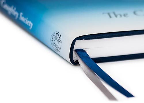 a close up of a copy of the caughley blue and white pattern book with detail of the double ribbons on the spine