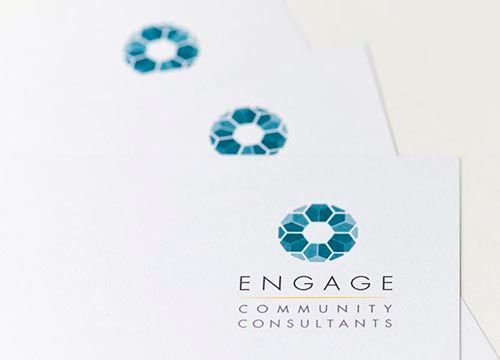 a close up of a business card for engage community consultants .
