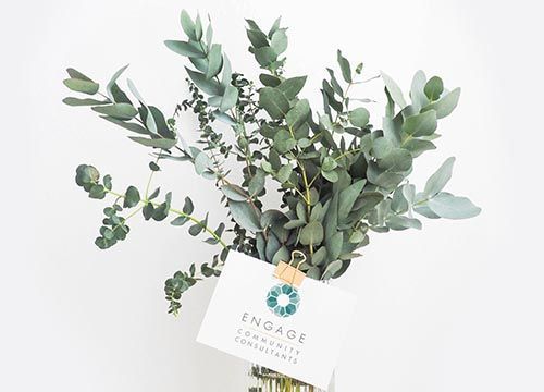 a bouquet of eucalyptus leaves with a card attached to it .