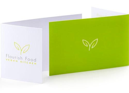a green and white business card for a vegan kitchen .