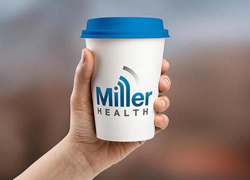 a person is holding a coffee cup with the miller health logo on it .