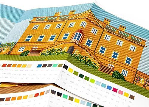A tapestry kit of a large building with a palette of colors