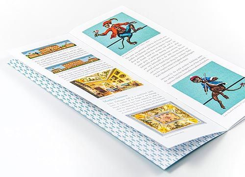A brochure with a picture of a jester and a monkey on it.