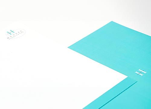 A close up of a blue envelope on a white surface.