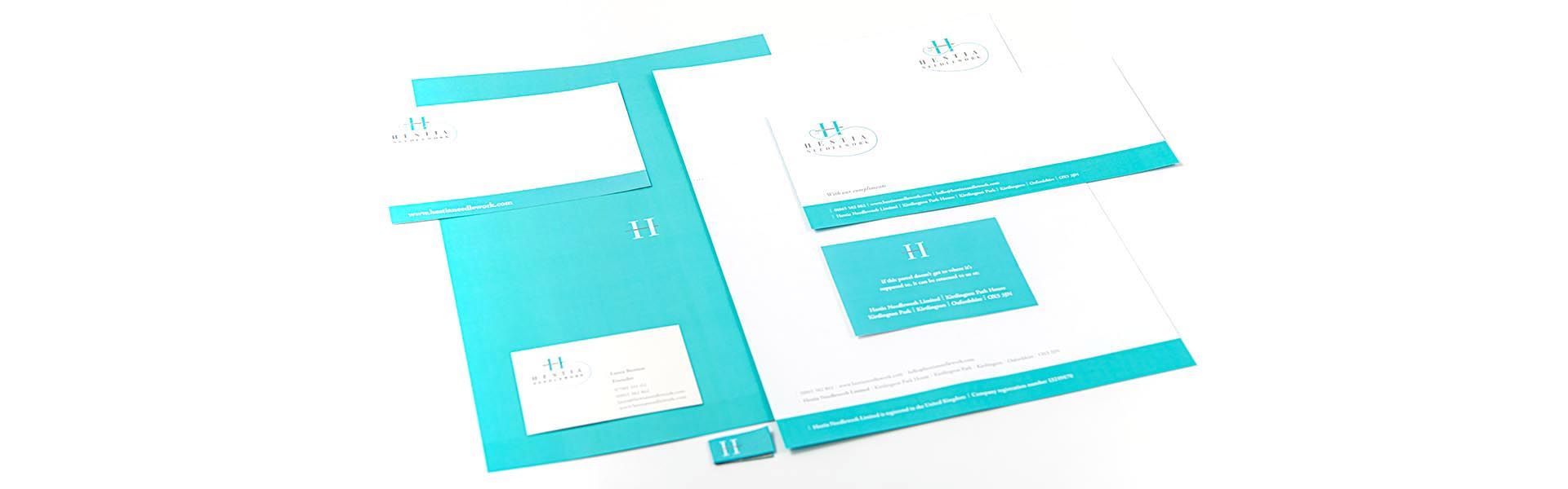 a set of business cards and a letterhead for hestia needlework 