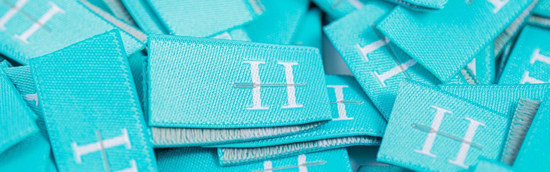 a pile of blue labels with the letter h on them .
