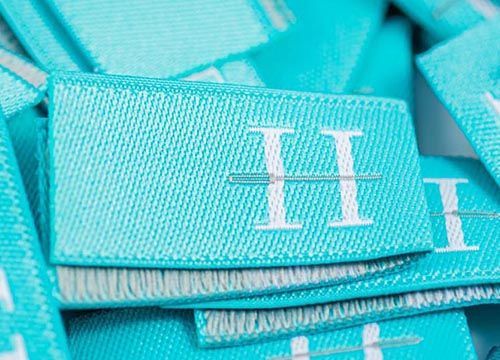 A pile of blue labels with the letter h on them.