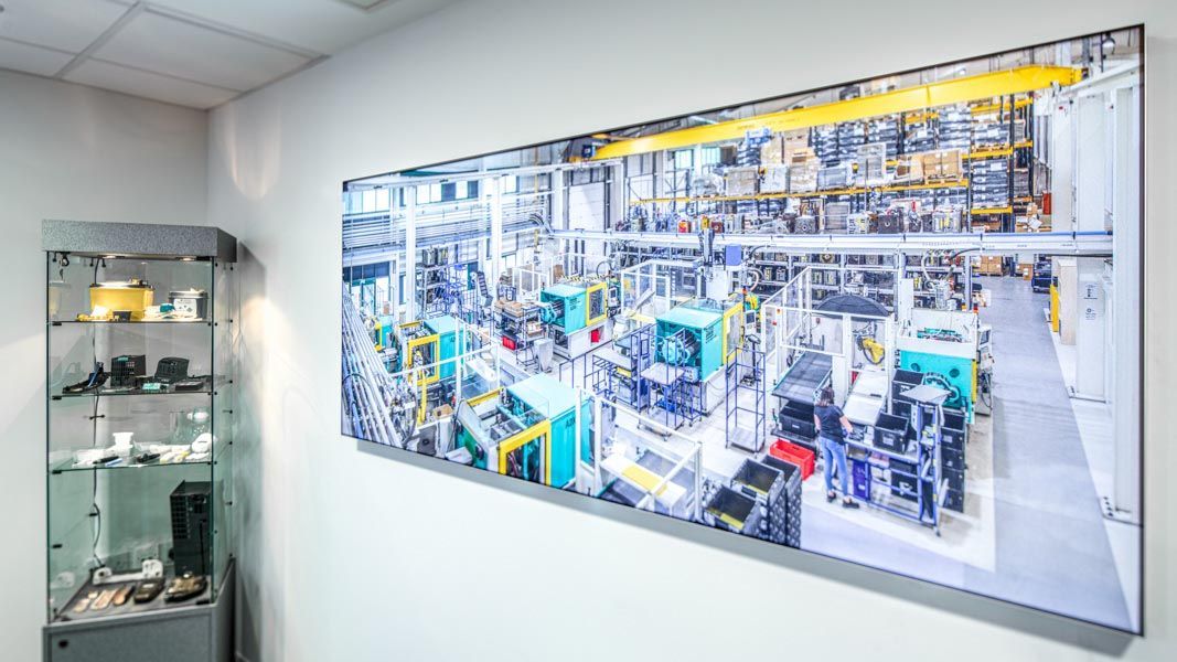 a large illuminated panoramic photograph displays a factory with a siemens logo on it
