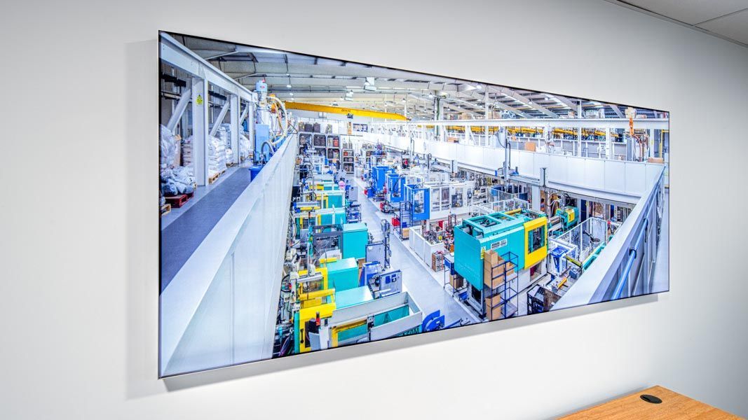 a large picture of a factory with a blue machine that says ecg on it