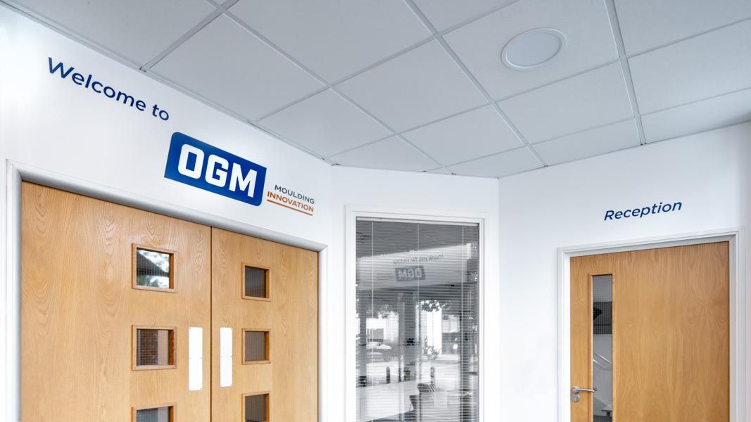 a sign that says welcome to ogm molding innovation