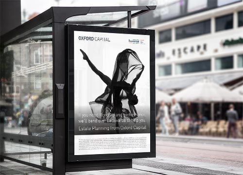 a bus stop with an adshel poster of a woman dancing on it for oxford capital.