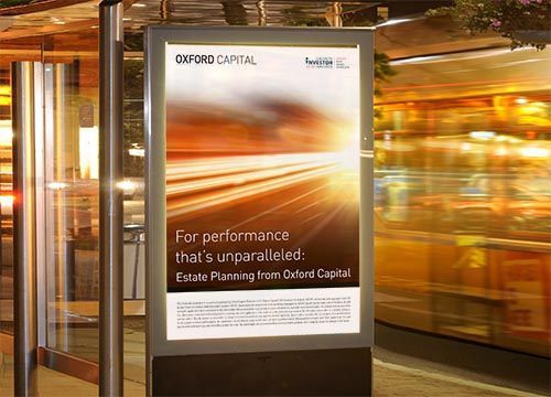 an adshel billboard advertisement for oxford capital is on a bus stop .