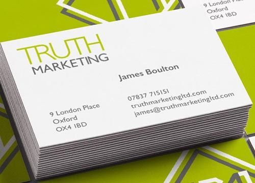 a stack of business cards sitting on top of each other on a green background .