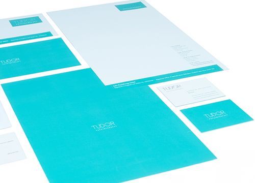 a set of tudor physiotherapy stationery is laid out on a table