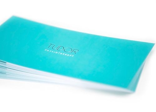 a stack of blue brochures sitting on top of each other on a white surface .