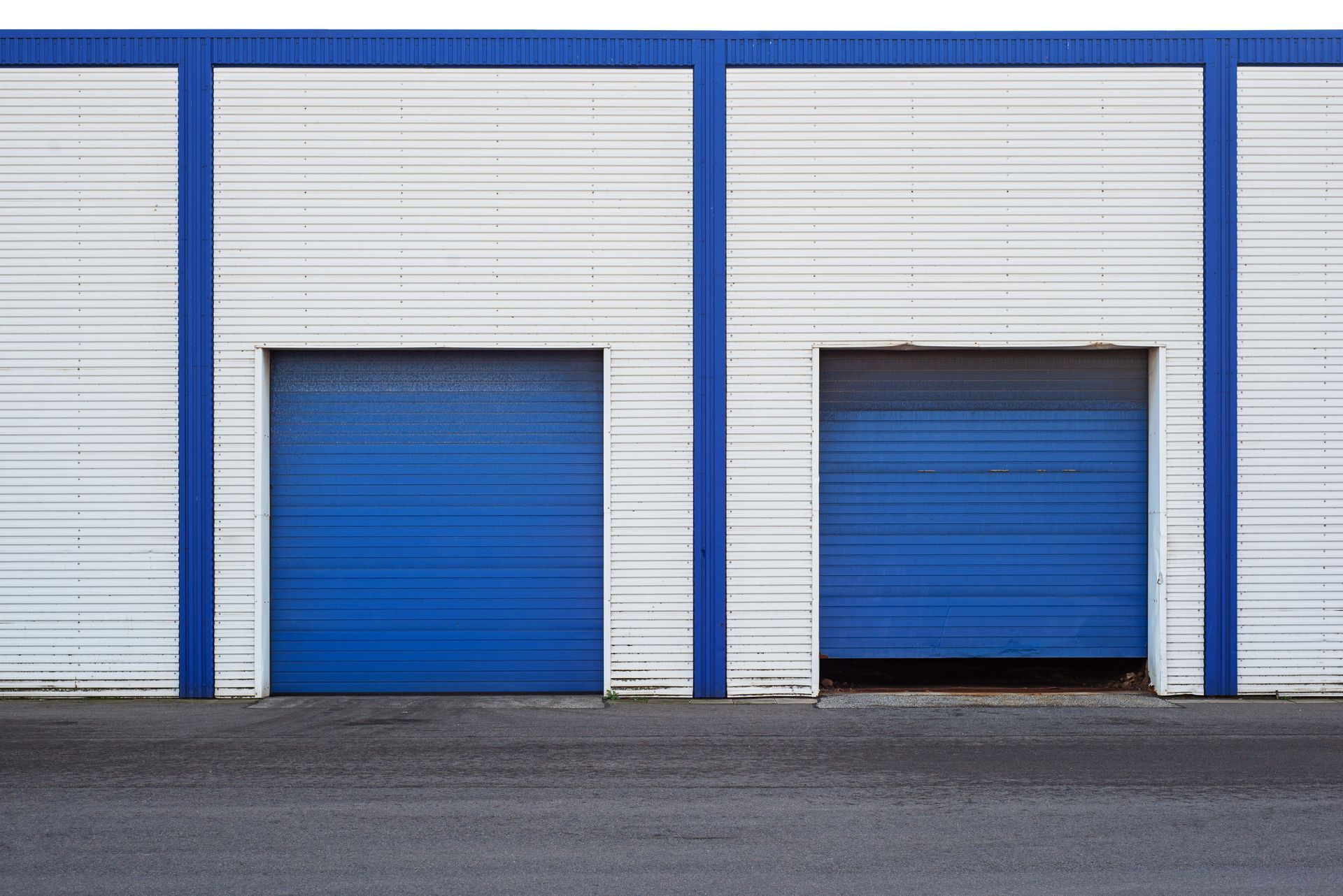 Blue warehouse doors on a white industrial building