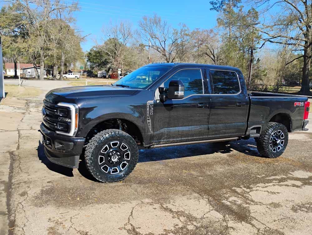 Dark gray Ford pickup truck parked outside on a sunny day.
