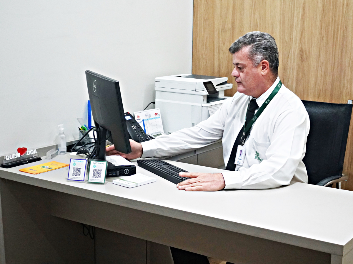 Um homem sentado em uma mesa usando um computador Dell
