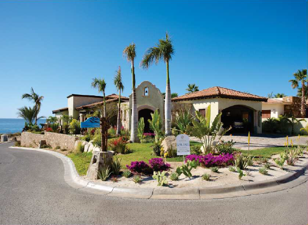 A large house with a lot of flowers in front of it