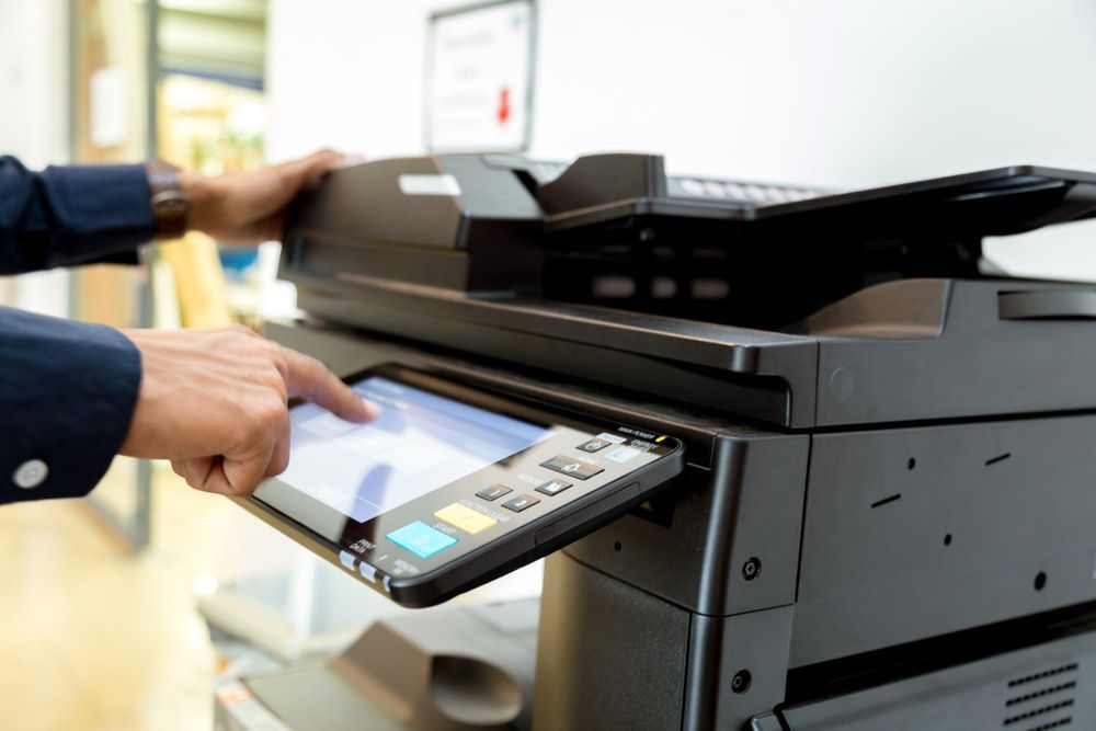 A Man is Using a Printer in an Office — Print Spot Group in South Murwillumbah, NSW