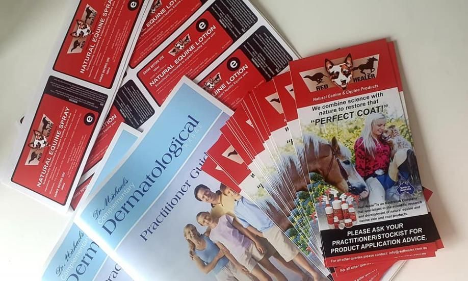 Red Flyers On Table — Print Spot Group in South Murwillumbah, NSW