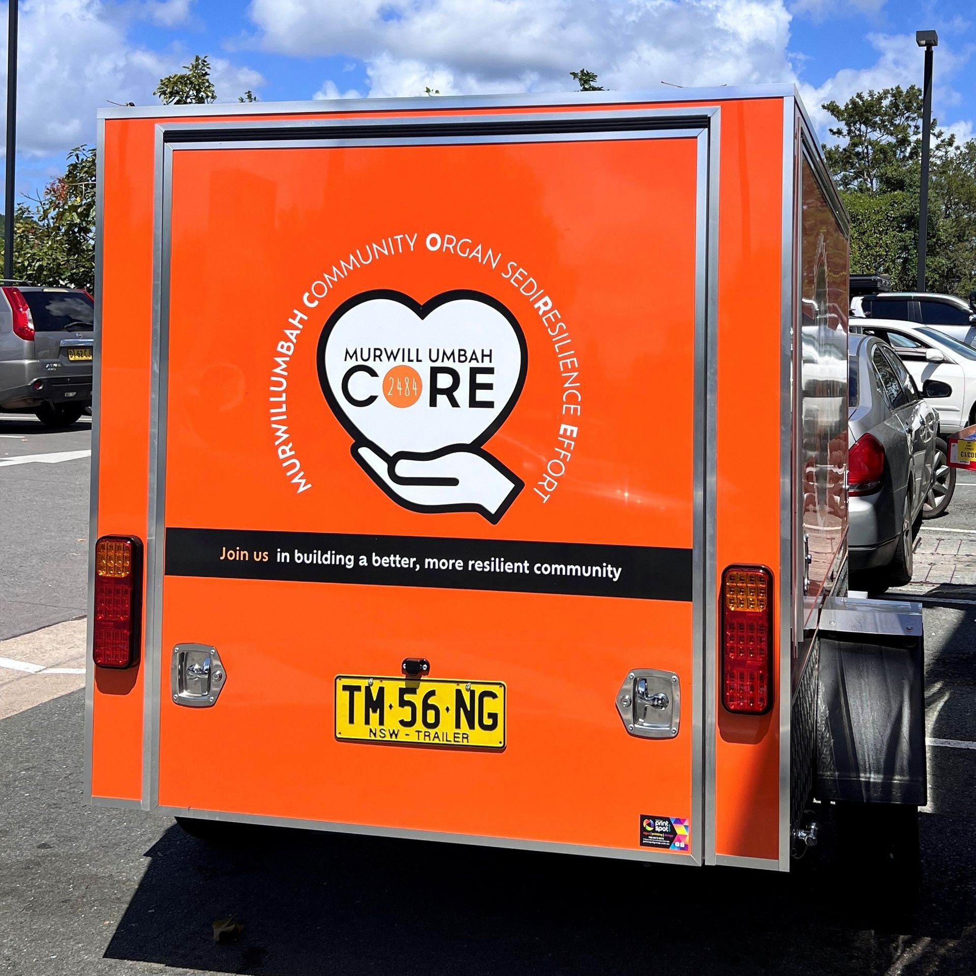 A White Dump Truck is Parked in a Parking Lot — Print Spot Group in South Murwillumbah, NSW