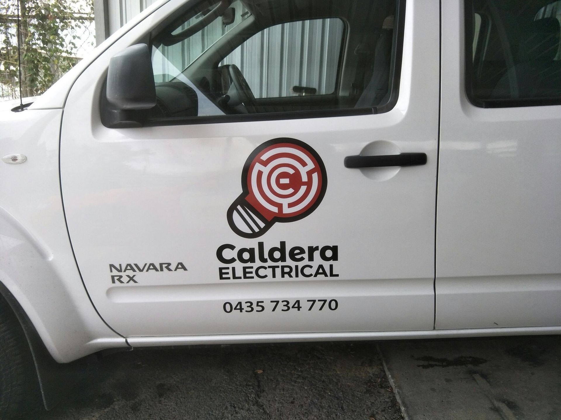 A White Van With Signed on the Back is Parked in a Garage — Print Spot Group in South Murwillumbah, NSW