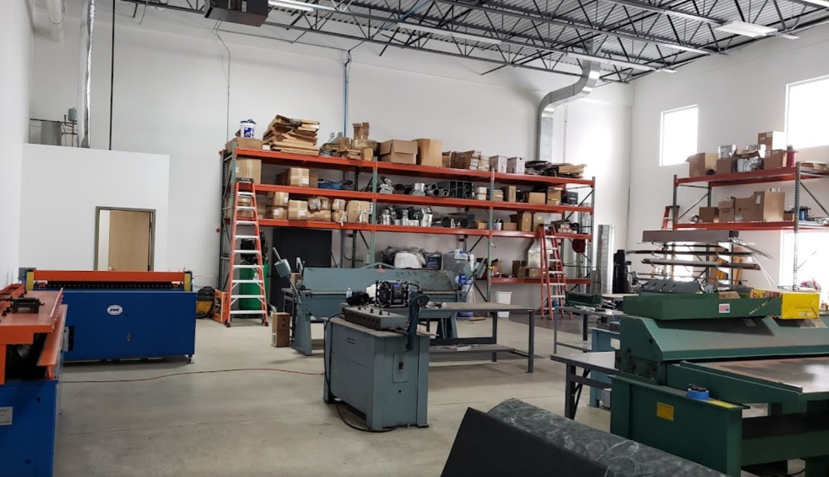 A large warehouse with lots of machinery and shelves