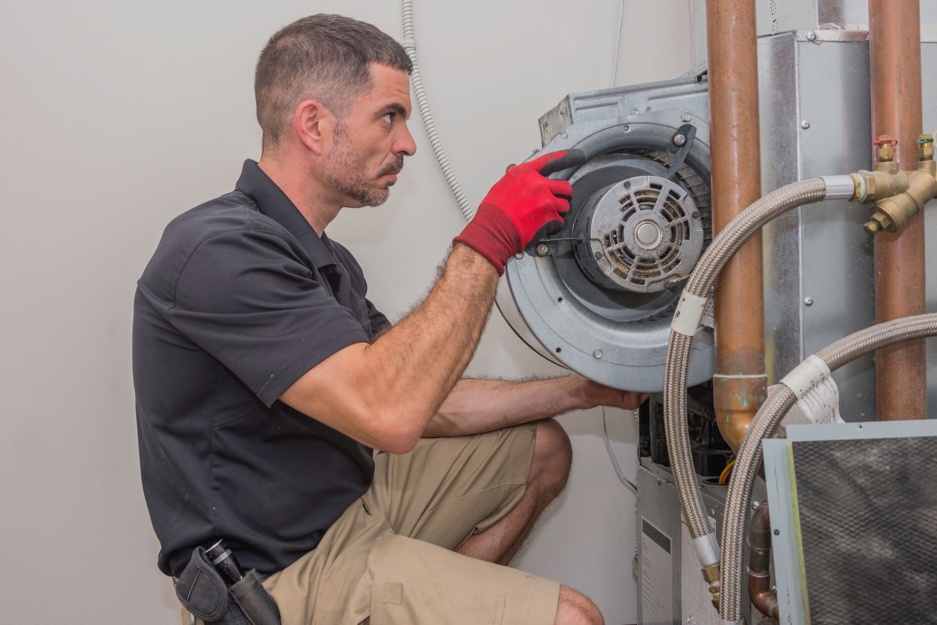 Hvac technition reinstalling motor after examining coils - commercial hvac coil cleaning