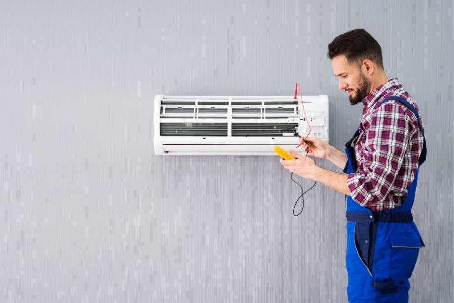 Man working on air balancing an HVAC system