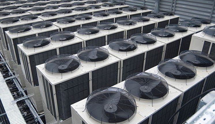 Many AC units on a rooftop awaiting commercial HVAC service in Lombard, IL.