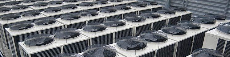 Many AC units on a rooftop awaiting commercial HVAC service in Lombard, IL.