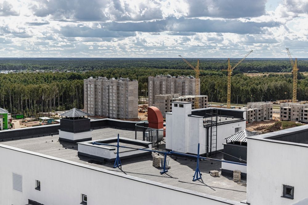 an aerial view of a high rise building under construction with an AC unit.