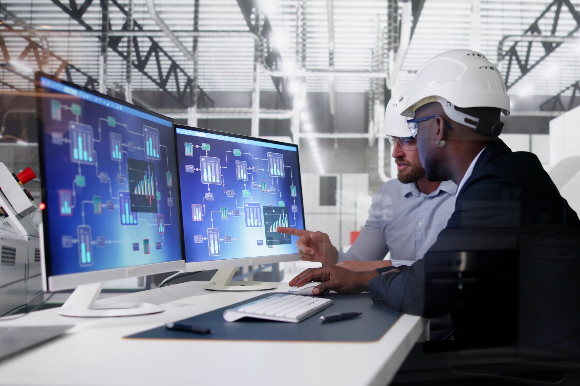 two men are looking at a computer screen setting up HVAC building control