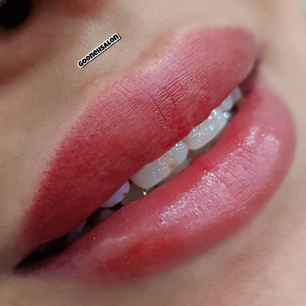 Close-up of lips with a soft, natural pink semi-permanent lip blush tattoo, showing a smooth, even color finish.