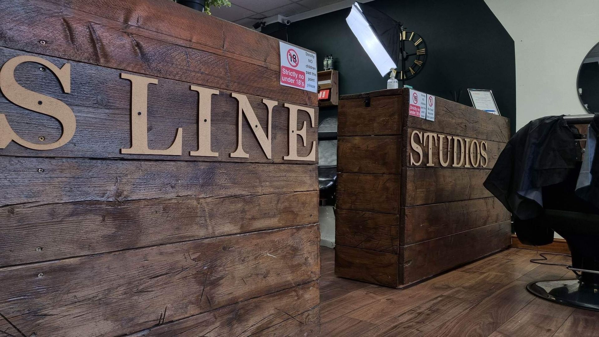 Two wooden reception desks with the text 