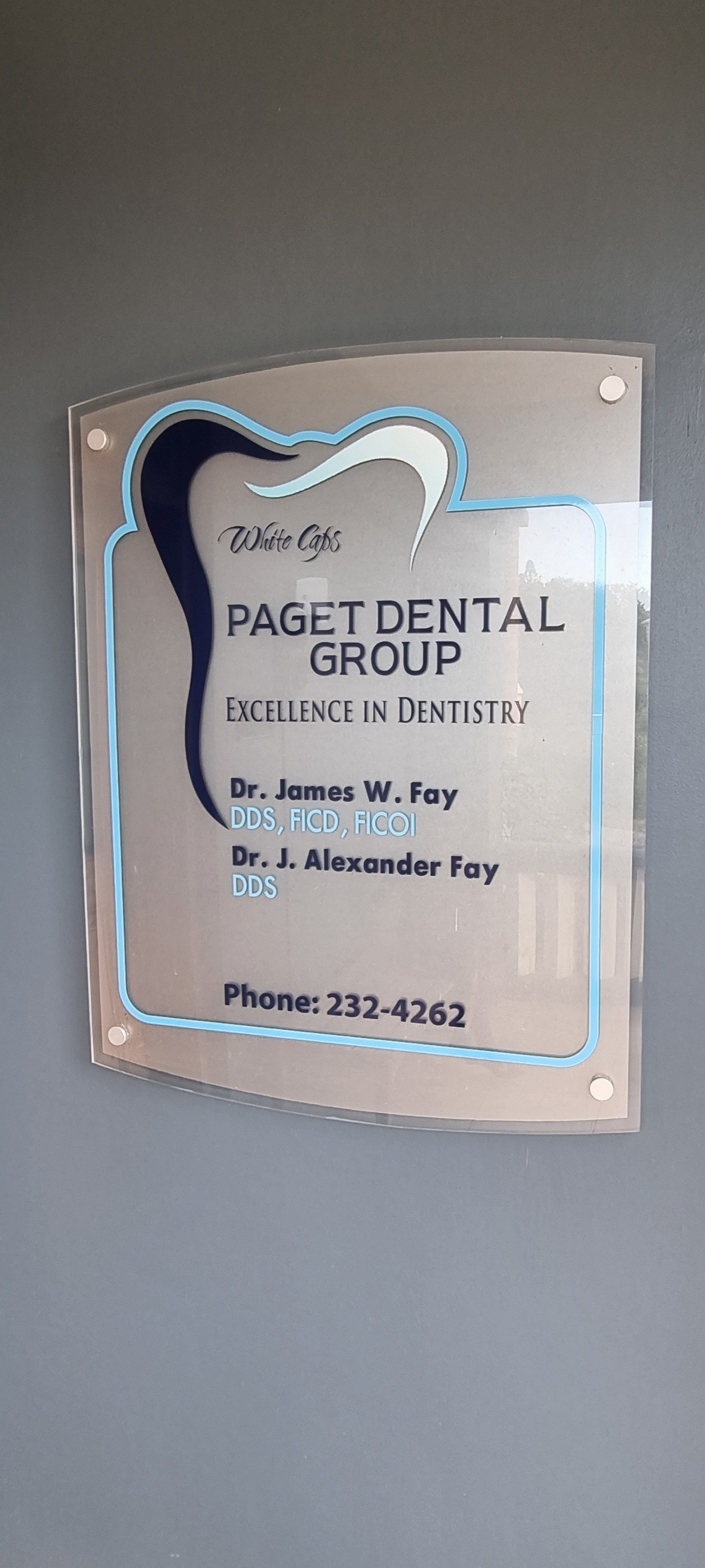 Paget Dental Group's office sign on the side of the building entry way