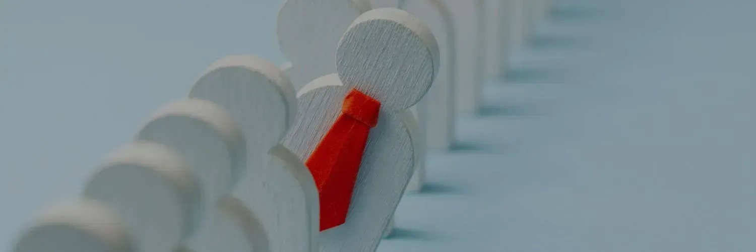 Red bow tie on a white dog collar among blurred white spools on a blue background
