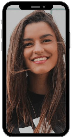 Woman with long brown hair, smiling widely on a phone screen.